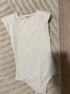 Babaton White Sleeveless Shoulder Pad One-Piece Bodysuit